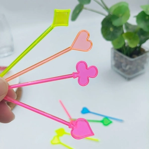 Close-up of colorful plastic picks featuring poker card suits for fruits and snacks