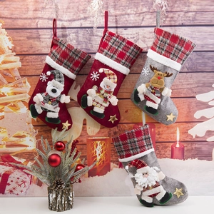 Detail of four plush Christmas stockings with 3D Santa, reindeer, snowman, and bear