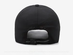 Detail of adjustable strap and plastic buckle on the back of a black mesh baseball cap