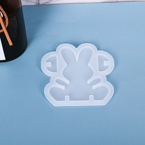 Detail showing translucent white silicone rabbit mold for DIY resin crafts on blue surface
