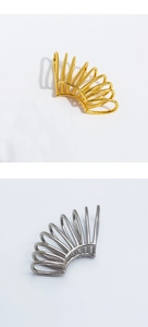 Detail view of gold and silver spiral ear cuffs with minimalist multi-layer metal lines