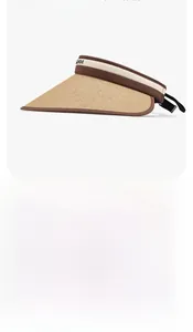 Detail showing woven straw brim and brand logo ribbon on sun visor with UV protection
