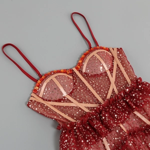 Detail of red sequin party dress featuring crystal neckline and mesh strap design