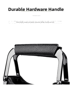 Detailed view of black pebbled leather handle with polished silver hardware attachment