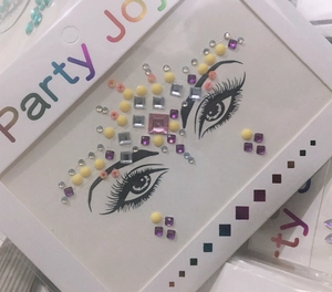 Close-up of colorful rhinestone face jewels for makeup with pink and purple crystal gems