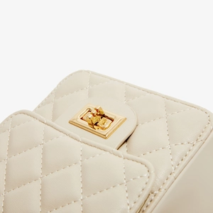 Classic beige quilted leather crossbody bag with elegant golden turn-lock closure detail