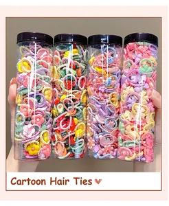 Set of four jars with colorful elastic hair ties featuring cute cartoon charms and floral icons