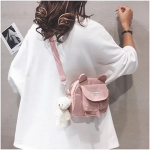 Pink bear canvas crossbody bag with cute animal ears and a white plush keychain