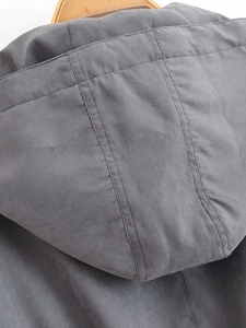 Detail of dark gray drawstring hoodie showing cotton twill fabric and premium stitching