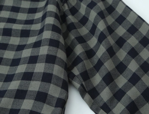 Macro shot of black and grey micro-check pattern on cotton twill shirt fabric