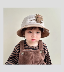 Detail of baby corduroy bucket hat featuring 3D bear plush and Lucky label