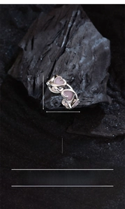 Macro detail of copper silver plated ring with pink enamel hollow heart patterns