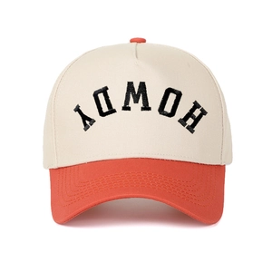 Close-up of inverted HOWDY embroidery on cream and orange contrast five-panel cap