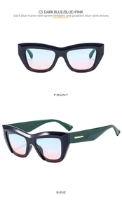 Close-up of dark blue cat-eye sunglasses with gradient blue-pink lenses and gold metal accents