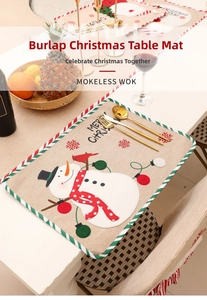 Close-up of linen Christmas placemat featuring a snowman and festive table setting