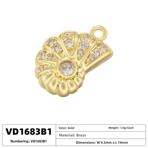 Detailed view of a gold seashell pendant with cubic zirconia, size 14mm by 9.5mm