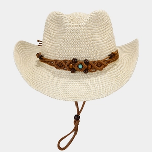 Detail of hand-woven straw hat featuring brown beaded band and turquoise stone accessory