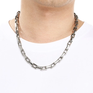 Close-up of polished 9mm silver square link chain necklace on male model's neck