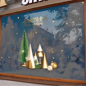 Golden and green Christmas tree window stickers with snowflakes on glass display