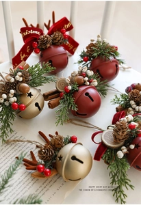Macro detail of Christmas bells with pine cones and red velvet bow embroidery