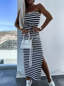 Sleeveless black and white striped knit midi dress with a side slit and slim fit silhouette