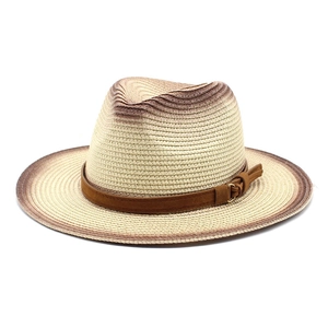 Close-up of woven straw hat with gradient color, suede band and metal ring buckle detail