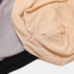 Detail of soft ribbed knit fabric texture in pink, grey and black slouchy beanies