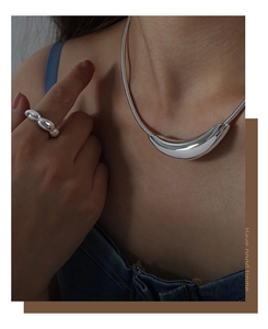 Silver minimalist curved pendant snake chain necklace and beaded ring worn by model