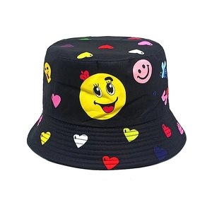 Detailed view of kids bucket hat featuring colorful cartoon smiley face and heart prints