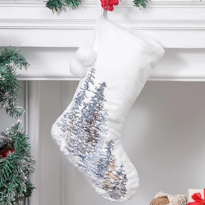 Detail of white faux rabbit fur Christmas stocking with blue forest tree embroidery