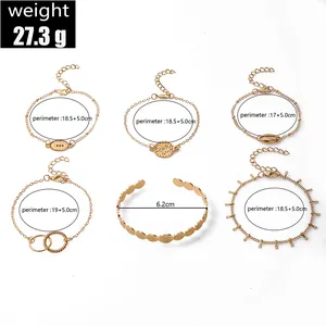Detailed size guide for gold charm bracelets with coin, butterfly and leaf motifs