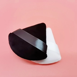 Set of black velvet and white triangular makeup powder puffs with ribbon handles
