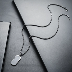 Close-up of titanium steel black geometric necklace with mesh chain and square pendant