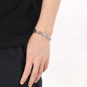 Sleek silver stainless steel coffee bean link bracelet shown on a model wrist