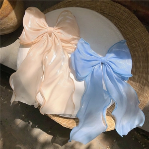 Elegant oversized mesh bow hair clip with long ribbons in champagne and sky blue