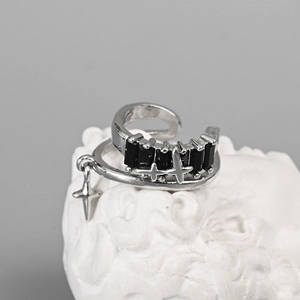 Detailed view of silver star ear cuff featuring black rectangular gems and star pendant