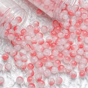 Macro view of 10mm red and white gradient glass beads for DIY jewelry making
