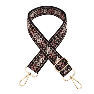 Detail of adjustable floral jacquard bag strap with golden swivel metal hooks