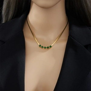 Elegant gold snake chain necklace featuring five green heart-shaped gemstone pendants