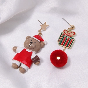 Detail of Christmas earrings featuring plush red balls, stars, and cartoon bear charms