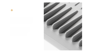 Close-up of grey silicone draining mat featuring foldable design and raised drain ridges