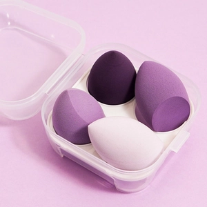 Detail of 4-piece purple gradient makeup sponges set in a clear plastic storage box