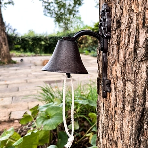 Vintage cast iron doorbell with keys shape and braided rope for garden wall decoration