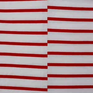 Detailed macro shot of red and white striped cotton fabric with precise seam alignment