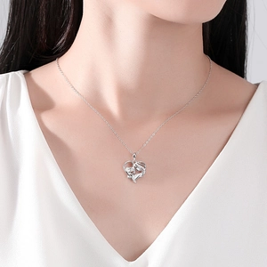 Elegant 925 sterling silver heart necklace featuring a mother and child pendant on a model