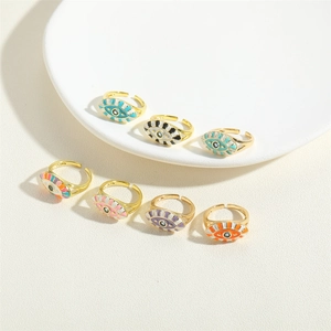 Set of gold enamel Evil Eye adjustable rings in multiple vibrant colors on white tray