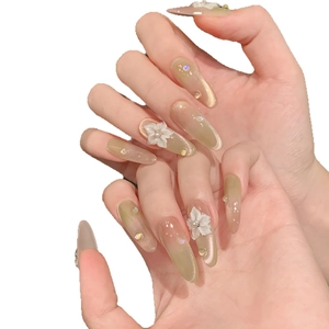 Handmade almond press-on nails with peach lime cat-eye gradient and 3D floral accents