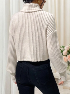Elegante suéter de punto acanalado crema con cuello alto y silueta corta ajustada de mujer