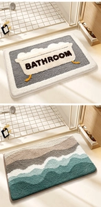 Detail of plush rainbow bath mat and grey bathroom mat with soft absorbent flocking texture