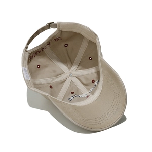 Detail view of cotton baseball cap interior showing 100% cotton label and stitching